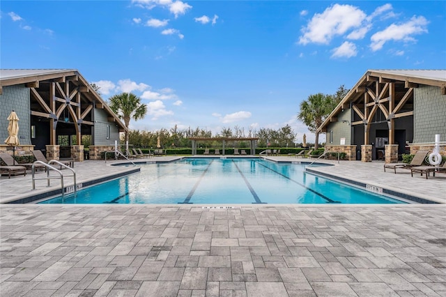 pool with a patio and a pergola