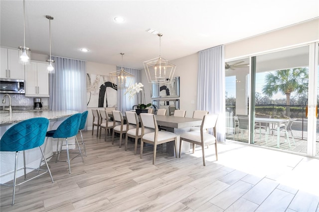 dining room featuring an inviting chandelier and light wood-type flooring