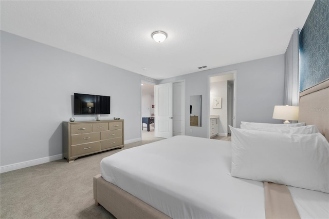 carpeted bedroom featuring ensuite bathroom