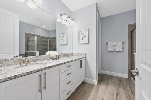 bathroom featuring vanity, hardwood / wood-style floors, and walk in shower