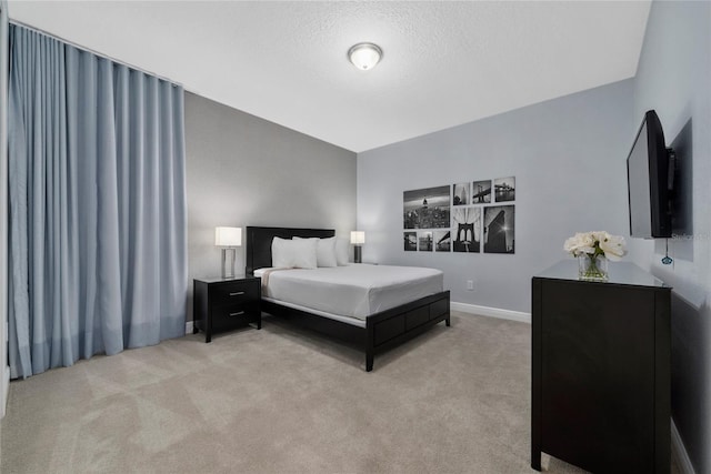 carpeted bedroom featuring a textured ceiling