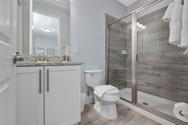 bathroom with vanity, toilet, and walk in shower