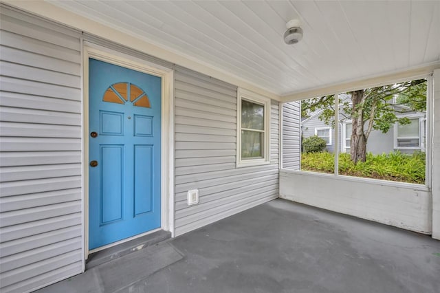 view of exterior entry with a porch