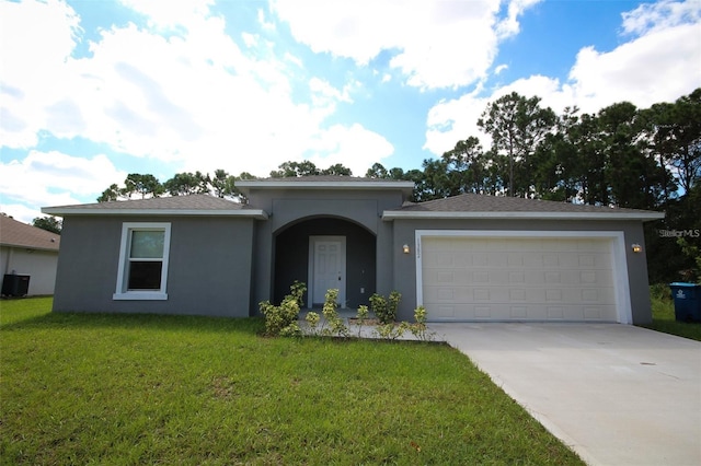 view of front facade with a garage and a front lawn