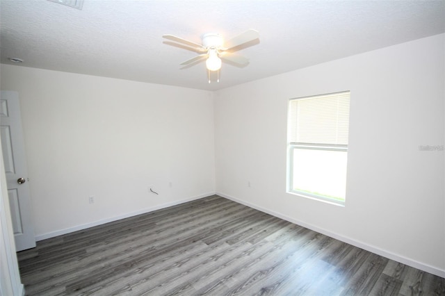 spare room featuring dark hardwood / wood-style floors and ceiling fan