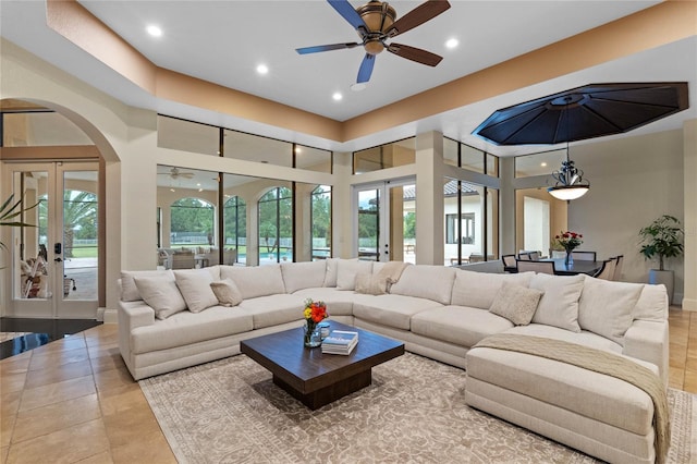 living room featuring ceiling fan, french doors, and a healthy amount of sunlight