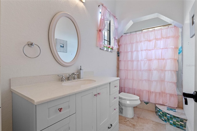 bathroom with vanity, tile patterned floors, toilet, and walk in shower