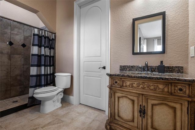 bathroom featuring vanity, curtained shower, and toilet