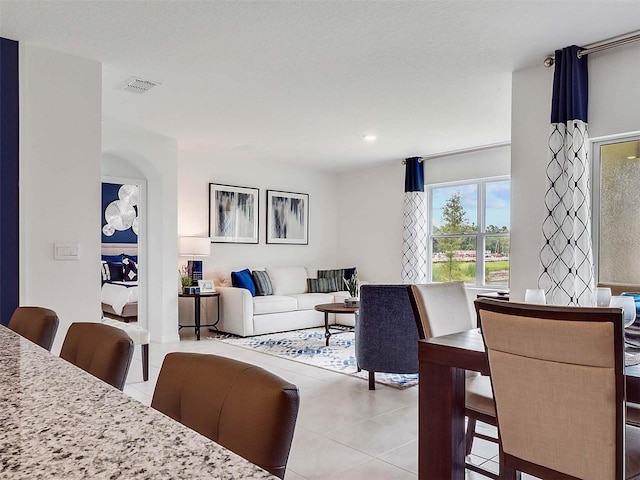 dining space featuring light tile patterned floors