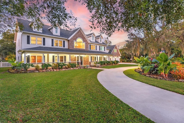 view of front of property featuring a yard and covered porch