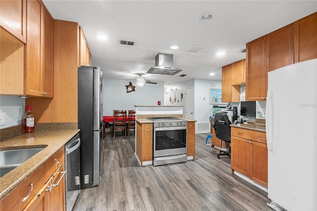 kitchen featuring appliances with stainless steel finishes, dark hardwood / wood-style floors, sink, island exhaust hood, and ceiling fan