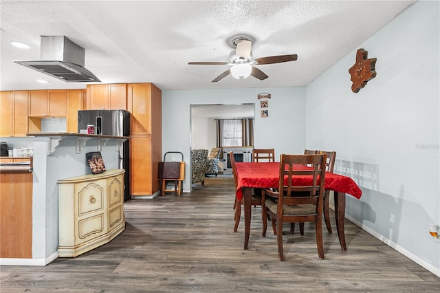 dining room featuring ceiling fan, dark hardwood / wood-style floors, and a textured ceiling