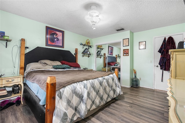 bedroom featuring hardwood / wood-style flooring, a closet, and a textured ceiling