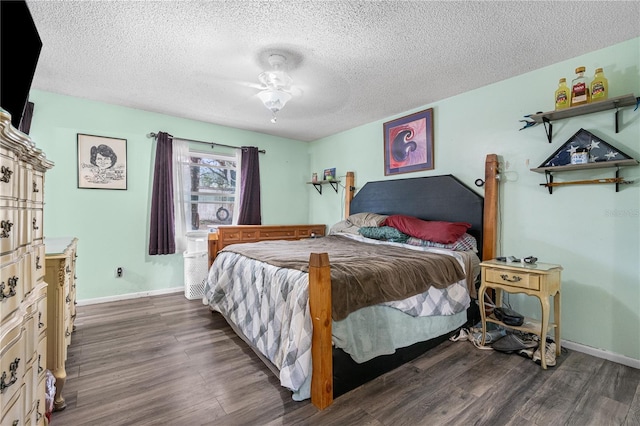 bedroom featuring ceiling fan, dark hardwood / wood-style flooring, and a textured ceiling