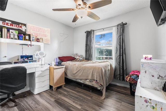 bedroom featuring ceiling fan, dark hardwood / wood-style floors, and a textured ceiling