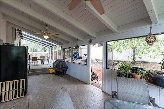 sunroom featuring lofted ceiling with beams and ceiling fan