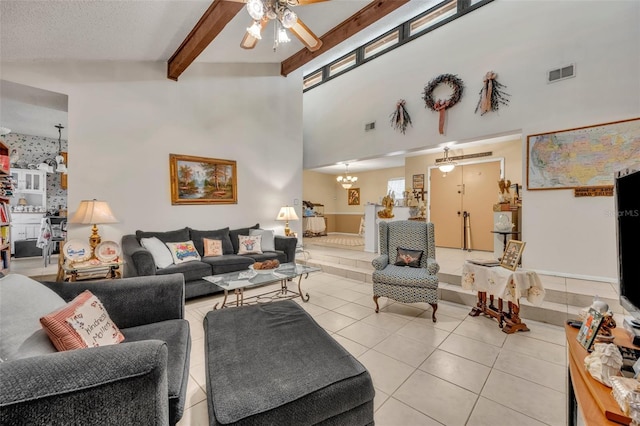 living area featuring light tile patterned floors, visible vents, beam ceiling, and ceiling fan with notable chandelier