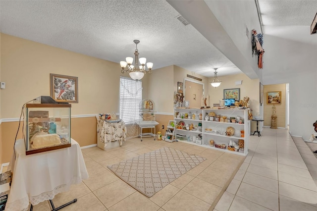 game room featuring tile patterned flooring, visible vents, a chandelier, and a textured ceiling