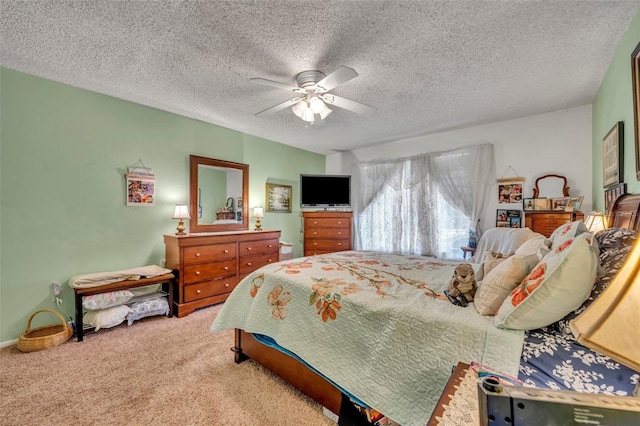 carpeted bedroom with a textured ceiling and a ceiling fan