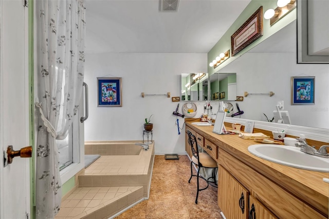 full bath with a relaxing tiled tub, double vanity, curtained shower, visible vents, and a sink