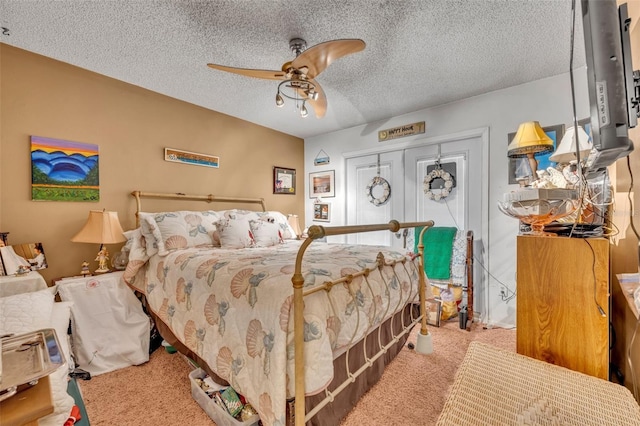 bedroom with a textured ceiling, ceiling fan, and carpet