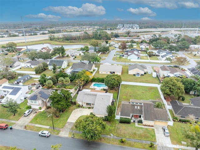 birds eye view of property featuring a residential view and a water view