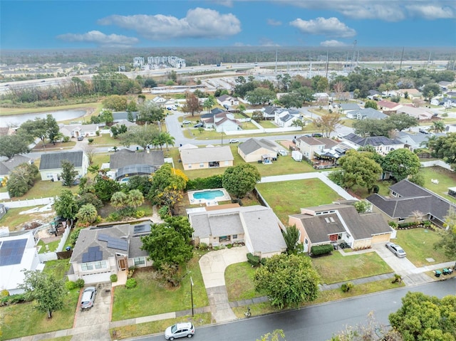 drone / aerial view featuring a water view and a residential view