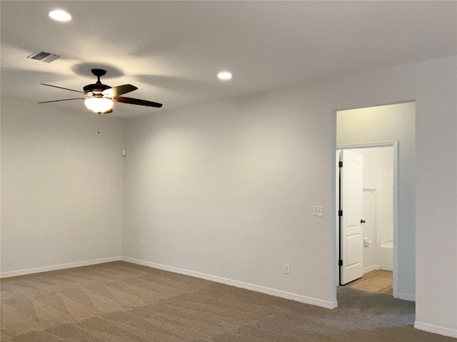 carpeted spare room featuring ceiling fan