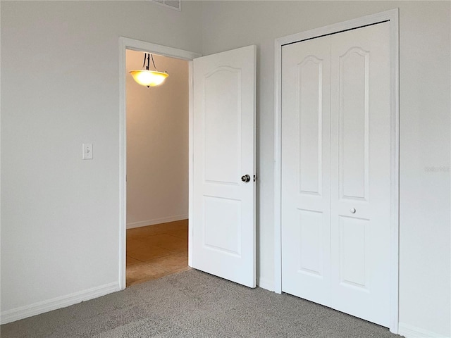 unfurnished bedroom with a closet and carpet