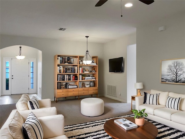 carpeted living room featuring ceiling fan