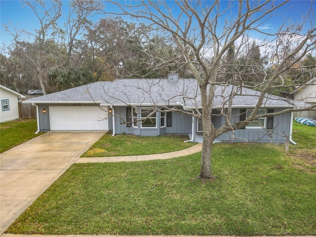 ranch-style home featuring a garage and a front lawn