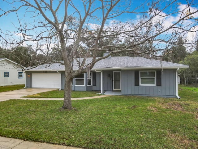 ranch-style house featuring a garage and a front lawn