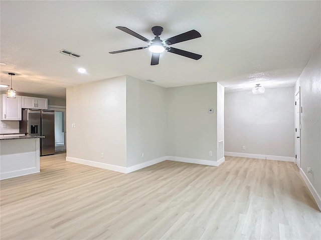 unfurnished living room featuring light hardwood / wood-style floors and ceiling fan