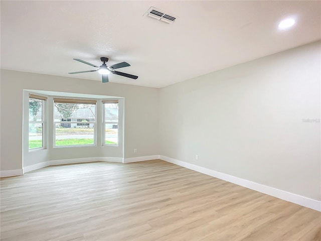 empty room featuring ceiling fan and light hardwood / wood-style floors