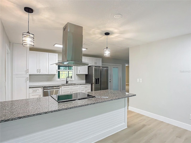 kitchen featuring sink, dark stone countertops, hanging light fixtures, stainless steel appliances, and white cabinets