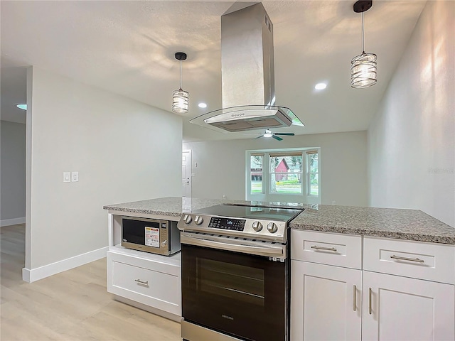 kitchen featuring white cabinets, stainless steel appliances, decorative light fixtures, and island range hood