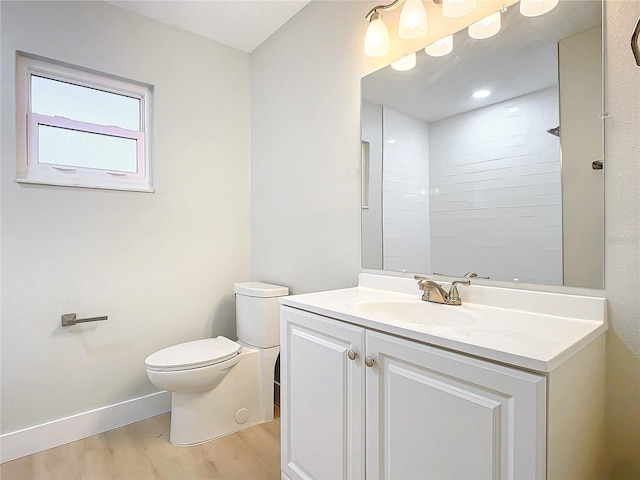 bathroom featuring walk in shower, wood-type flooring, toilet, and vanity