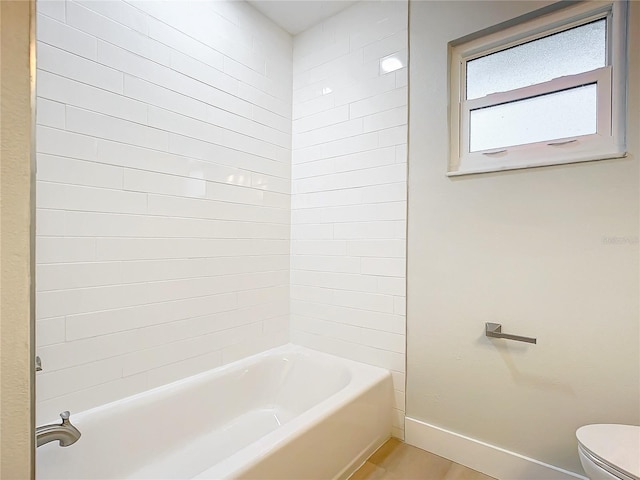 bathroom with  shower combination, hardwood / wood-style floors, and toilet