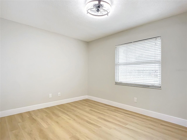 unfurnished room with light hardwood / wood-style floors