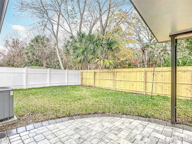 view of yard featuring a patio and central air condition unit