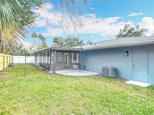 back of property featuring central AC unit, a yard, a patio area, and a sunroom