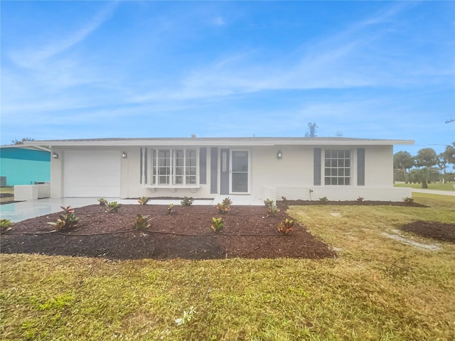 single story home featuring a garage and a front lawn