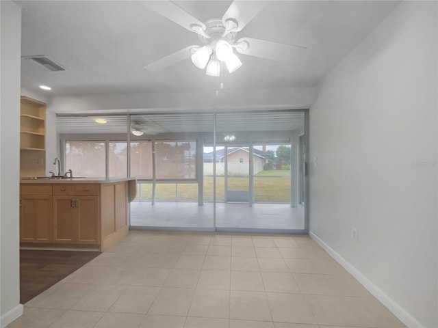 interior space with sink and ceiling fan