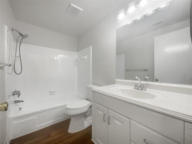 full bathroom with shower / bathing tub combination, hardwood / wood-style floors, vanity, and toilet