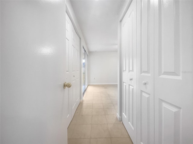 hall with light tile patterned floors