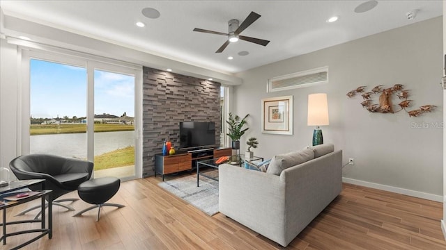 living room with hardwood / wood-style flooring and ceiling fan