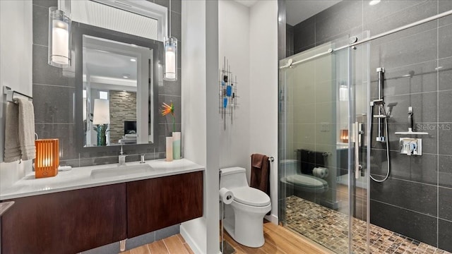 bathroom with vanity, walk in shower, and toilet