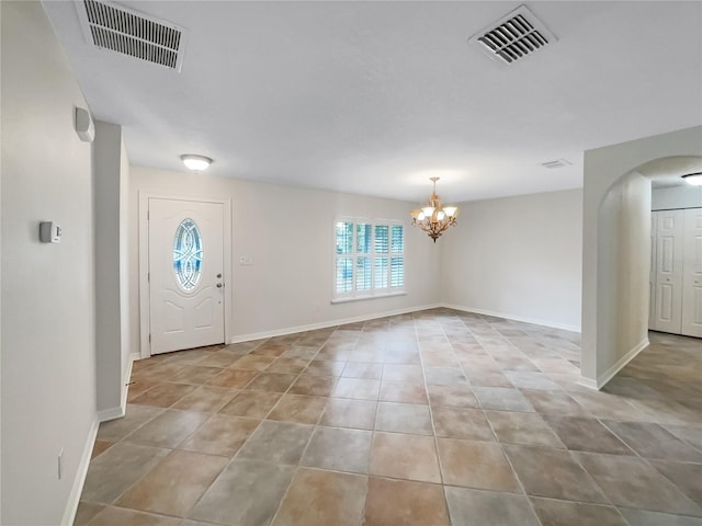 foyer entrance with an inviting chandelier