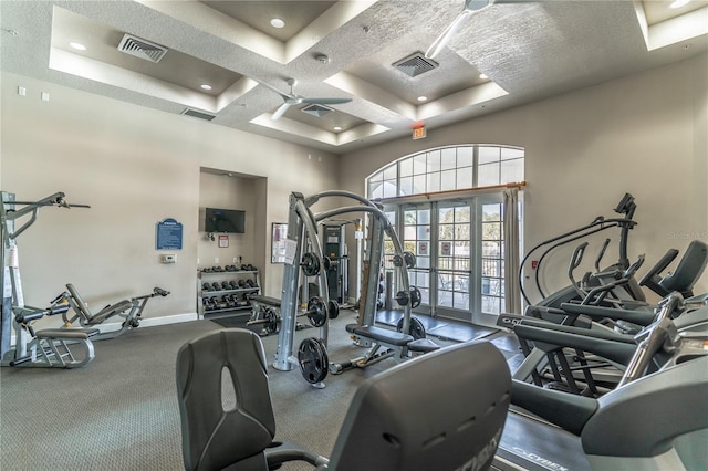 gym featuring a high ceiling, coffered ceiling, a textured ceiling, and french doors