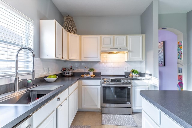 kitchen with white cabinetry, stainless steel appliances, sink, and backsplash